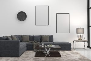 Smooth acrylic render in a modern living room with a dark gray sectional sofa, sleek coffee table, and minimalist decor elements including a wall clock, lamp, and framed artwork, showcasing a clean and contemporary interior design.