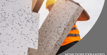 Construction worker installing a large white expanded polystyrene cladding panel on a building exterior for insulation.