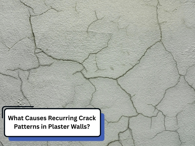 A close-up of a wall showing significant crack patterns across its plaster surface.