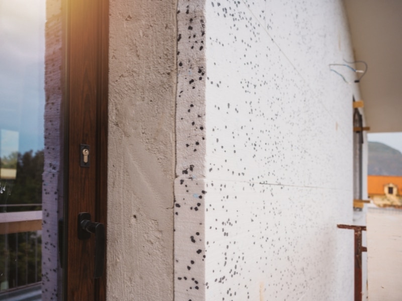 External wall fitted with rendered polystyrene cladding during installation phase