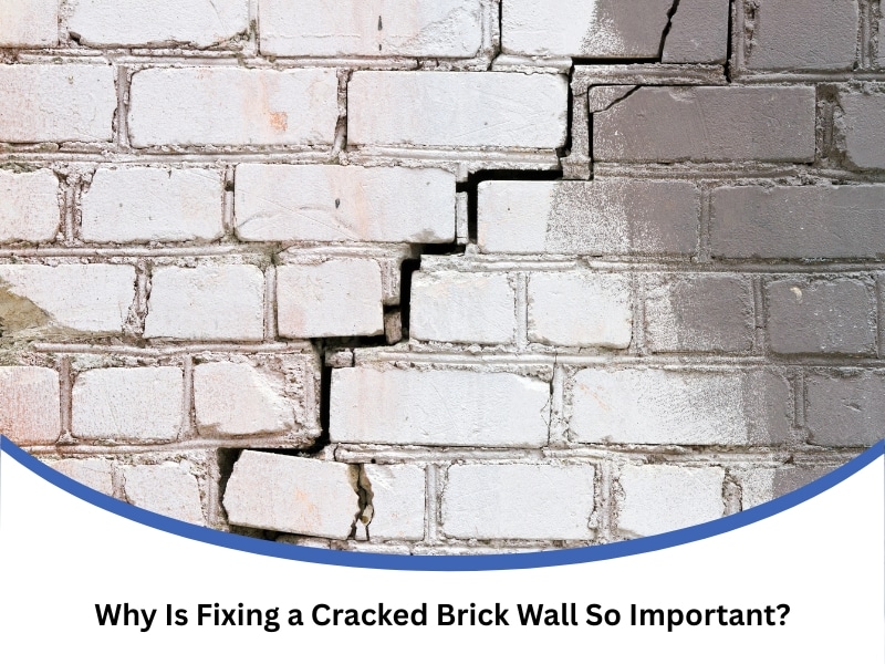 Heavily cracked white brick wall showing advanced damage needing urgent fixing a cracked brick wall