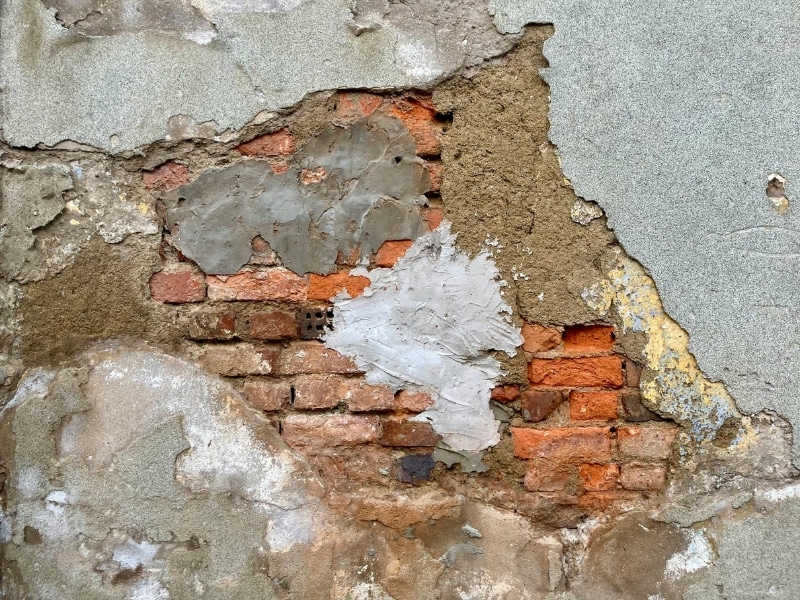 Poorly maintained surface showing problems when you render exterior wall without preparation.