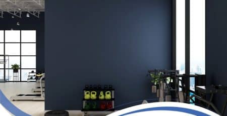 acrylic render colours in dark blue finish on modern gym wall with fitness equipment.