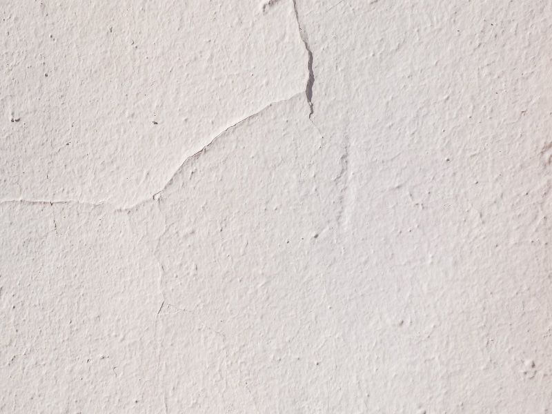 cracks on painted surface before painting over rendered walls