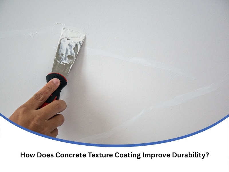 Hand applying concrete texture coating to a wall using a spatula for a smooth repair finish.