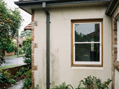 Hairline crack in a rendered wall near a window corner on a Sydney home.