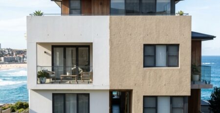 Sydney coastal home exterior in 2026, showing half with smooth painted finish and half with textured acrylic coating, bright afternoon light, subtle wear difference visible